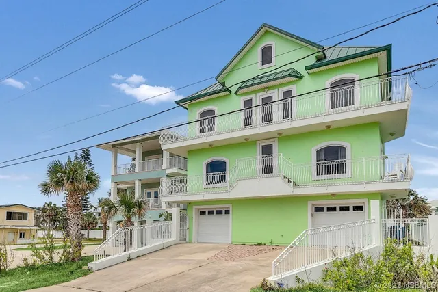 a large kitchen with a counter space a sink appliances and cabinets