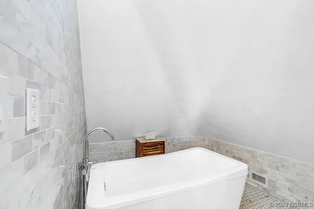 a kitchen with stainless steel appliances a sink a stove and white cabinets