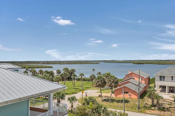 a aerial view of a house with a swimming pool and outdoor seating