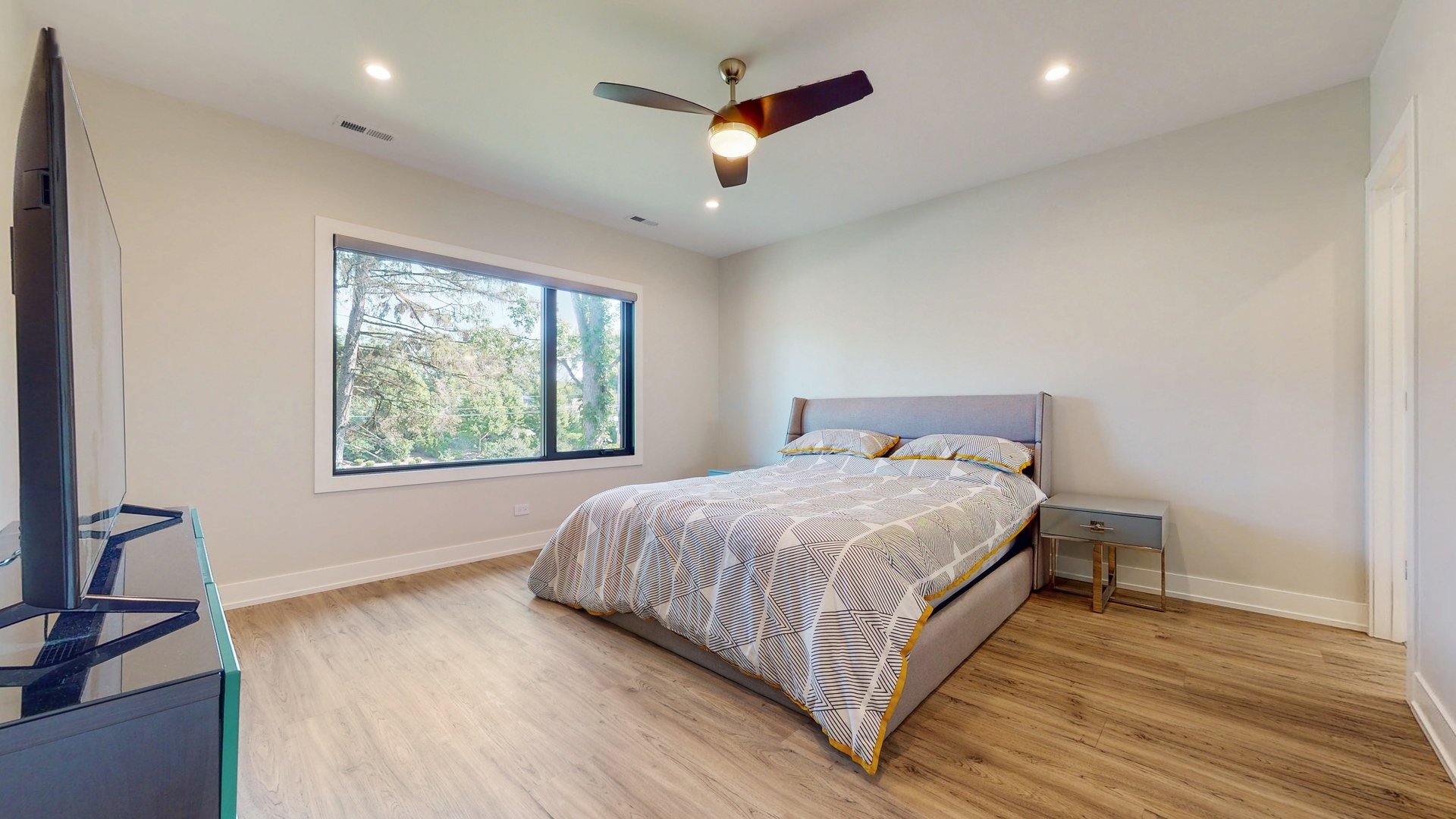 1 A Half Day Road Lincolnshire, IL 60069 - Photo 18 of 37 a bedroom with a large bed chandelier and a window
