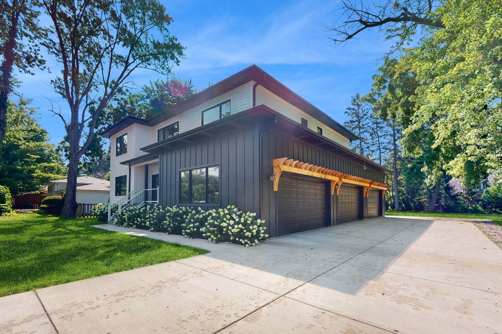 1 A Half Day Road Lincolnshire, IL 60069 - Photo 2 of 37 a front view of a house with a garden and plants