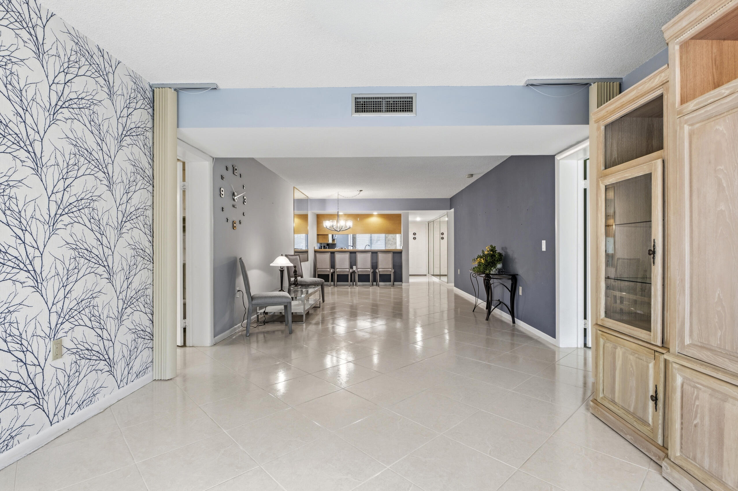 6145 Balboa Circle, Unit 103 Boca Raton, FL 33433 - Photo 8 of 31 a view of a livingroom with furniture and a ceiling fan