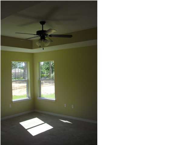 9685 Misty Meadow Lane Navarre, FL 32566 - Photo 11 of 18 a living room with a window and a ceiling fan
