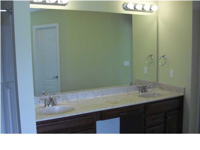 9685 Misty Meadow Lane Navarre, FL 32566 - Photo 12 of 18 a bathroom with a sink and a mirror