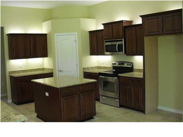 9685 Misty Meadow Lane Navarre, FL 32566 - Photo 5 of 18 a kitchen with stainless steel appliances granite countertop a refrigerator and a stove