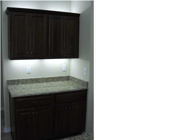 9685 Misty Meadow Lane Navarre, FL 32566 - Photo 6 of 18 a bathroom with a granite countertop sink and a mirror