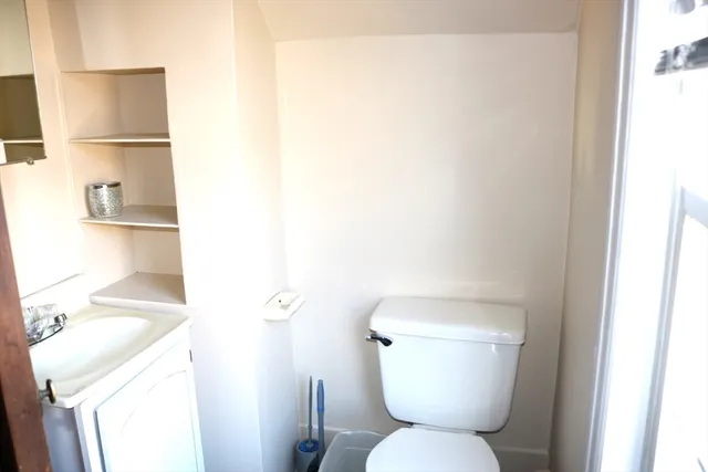a bathroom with a toilet a sink and a shower