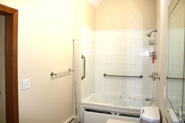 a bathroom with a shower and toilet
