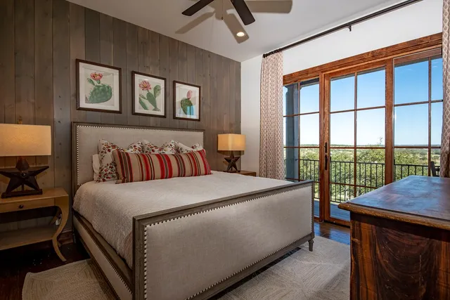 a bedroom with a bed and a large window