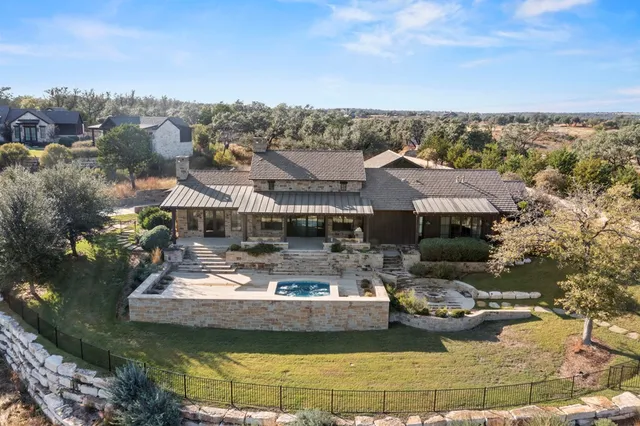 a view of a house with a garden and lake view