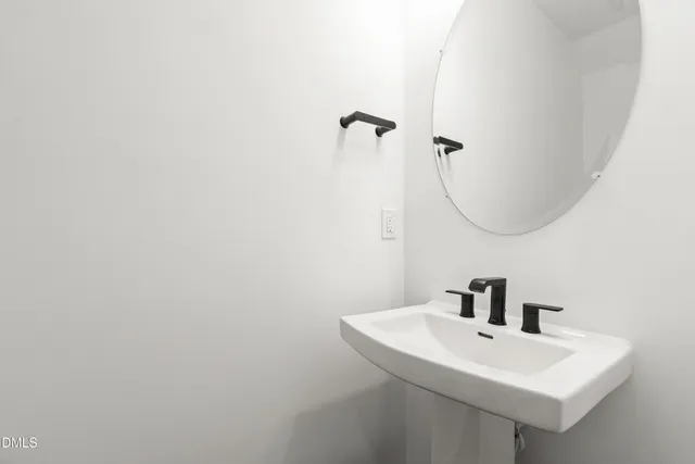 a bathroom with a sink a mirror and vanity