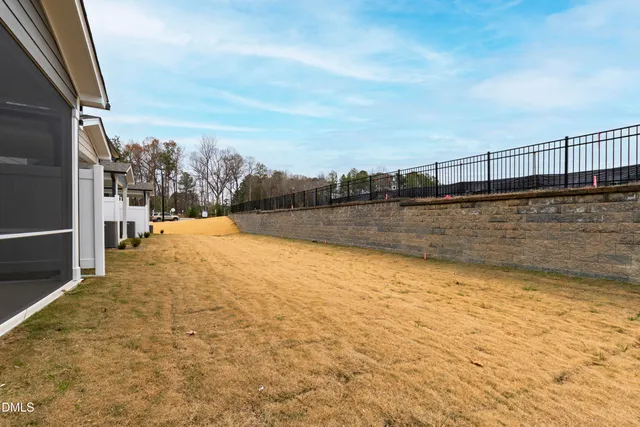 a view of a house with a wooden fence