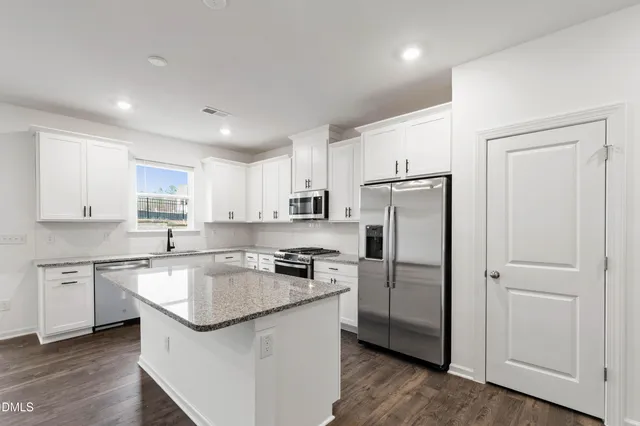 a kitchen with cabinets and stainless steel appliances