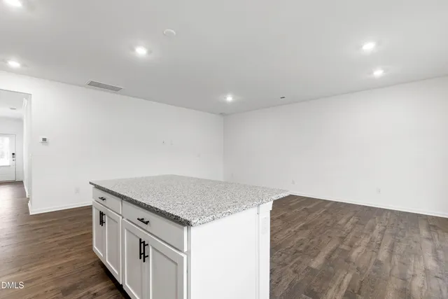 an empty room with wooden floor