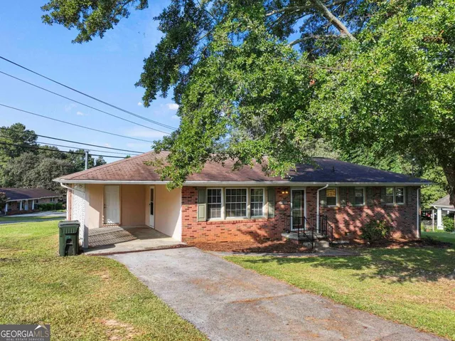 a view of a house with backyard porch and sitting area