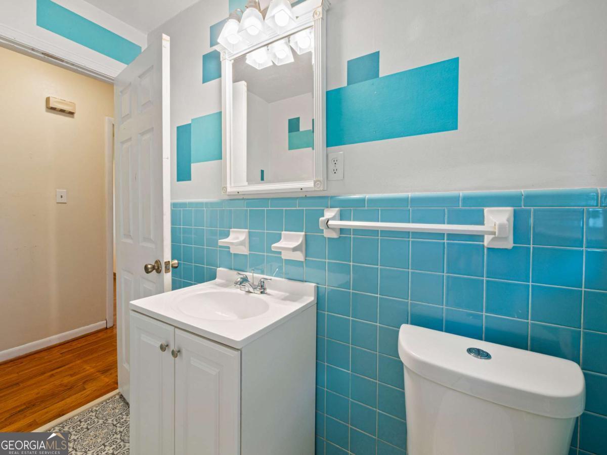 372 Hilltop Way Toccoa, GA 30577 - Photo 15 of 38 a bathroom with a toilet a sink and mirror