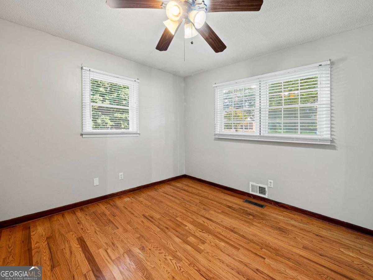 372 Hilltop Way Toccoa, GA 30577 - Photo 16 of 38 a view of an empty room with wooden floor and a window