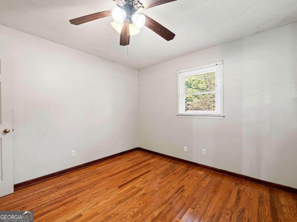 372 Hilltop Way Toccoa, GA 30577 - Photo 19 of 38 an empty room with a window and wooden floor