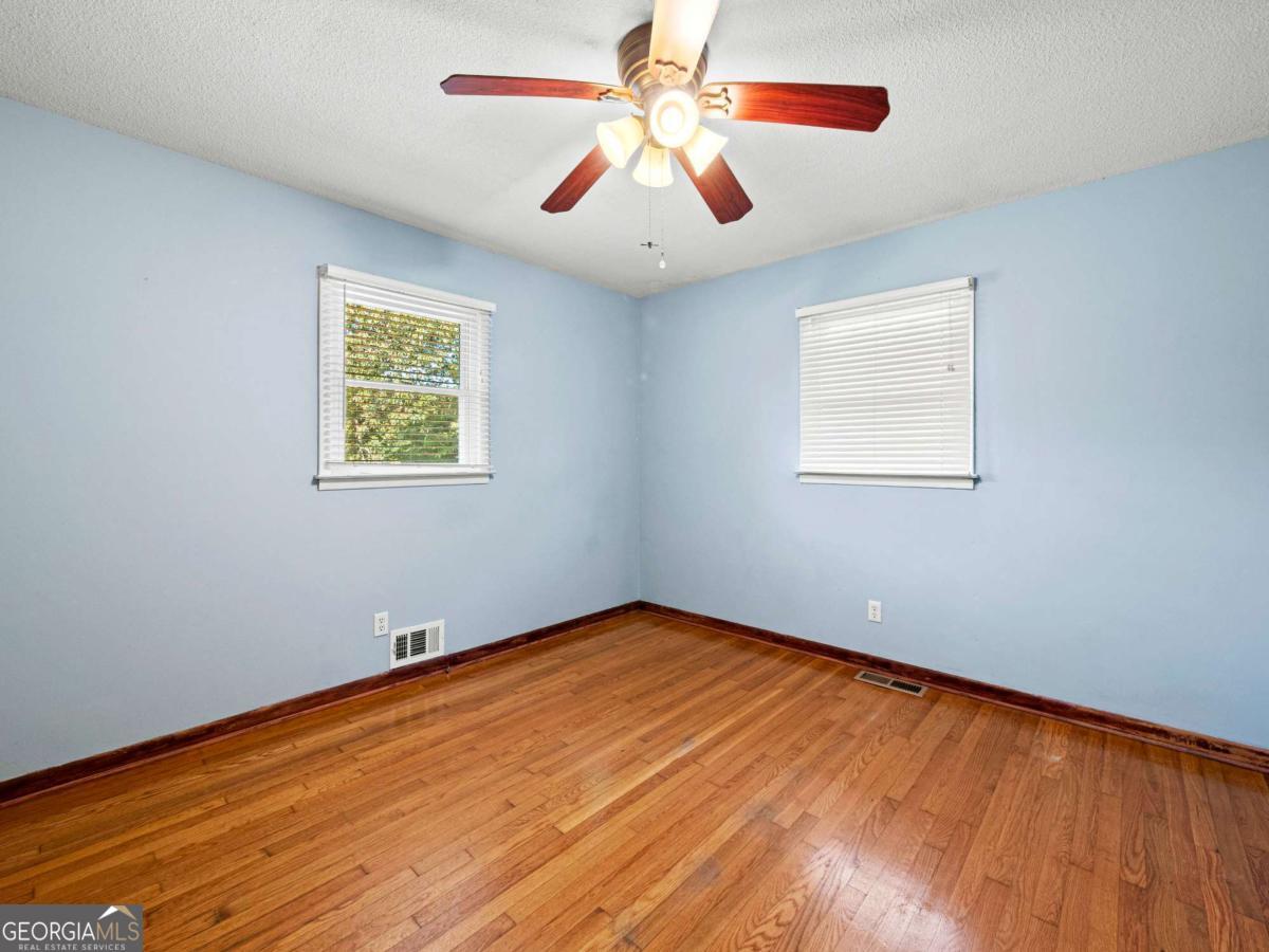 372 Hilltop Way Toccoa, GA 30577 - Photo 21 of 38 a view of an empty room with window and wooden floor