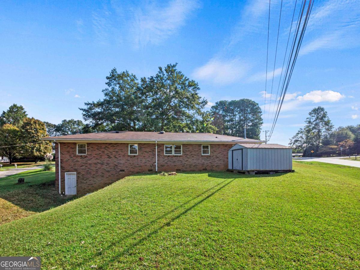 372 Hilltop Way Toccoa, GA 30577 - Photo 26 of 38 a view of a house with a yard and sitting area