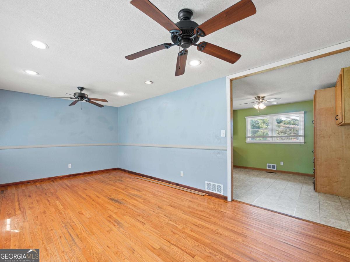 372 Hilltop Way Toccoa, GA 30577 - Photo 3 of 38 wooden floor in an empty room with a window