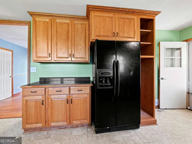 a kitchen with stainless steel appliances granite countertop a refrigerator and a cabinets