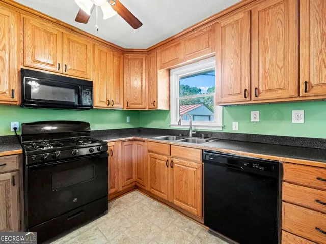 a kitchen with stainless steel appliances granite countertop a stove microwave and sink