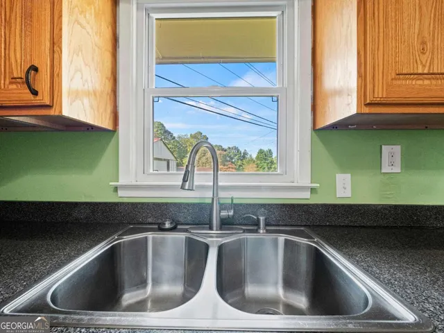 a kitchen with a sink and a window