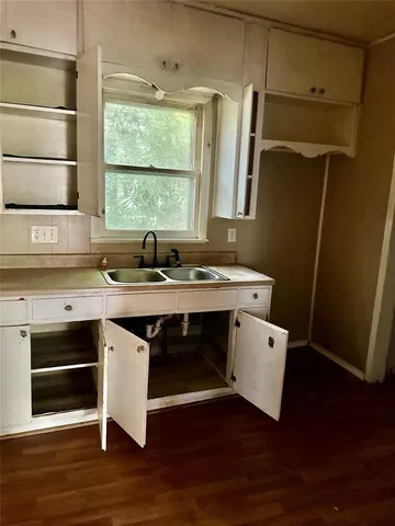 a room with wooden cabinets and a window