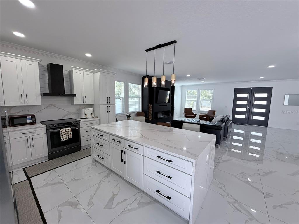 7403 Edgemere Road Tampa, FL 33625 - Photo 11 of 41 a kitchen with granite countertop a sink and cabinets