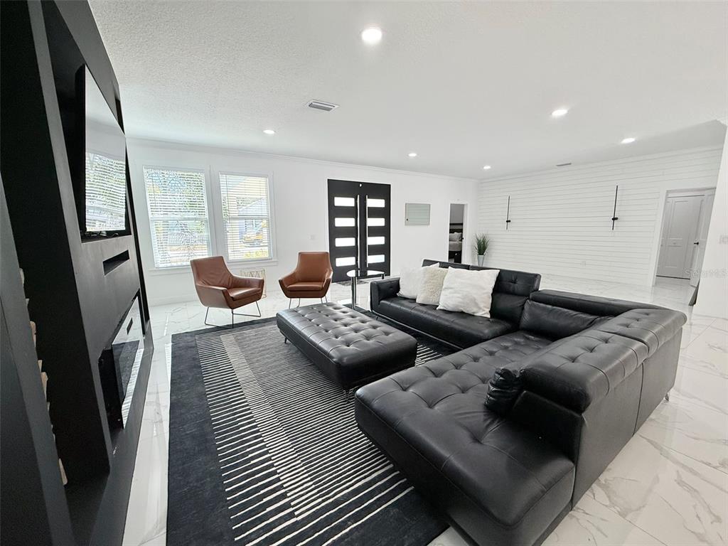7403 Edgemere Road Tampa, FL 33625 - Photo 15 of 41 a living room with furniture and a couch