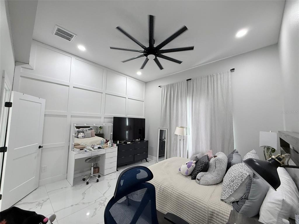 7403 Edgemere Road Tampa, FL 33625 - Photo 19 of 41 a bedroom with furniture and a bed