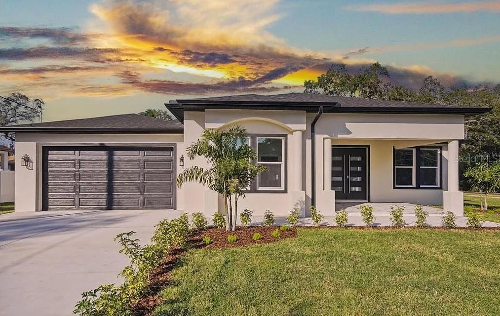 7403 Edgemere Road Tampa, FL 33625 - Photo 2 of 41 front view of a house with a big yard