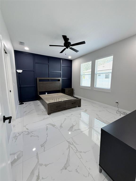 7403 Edgemere Road Tampa, FL 33625 - Photo 21 of 41 a living room with granite countertop furniture and a ceiling fan