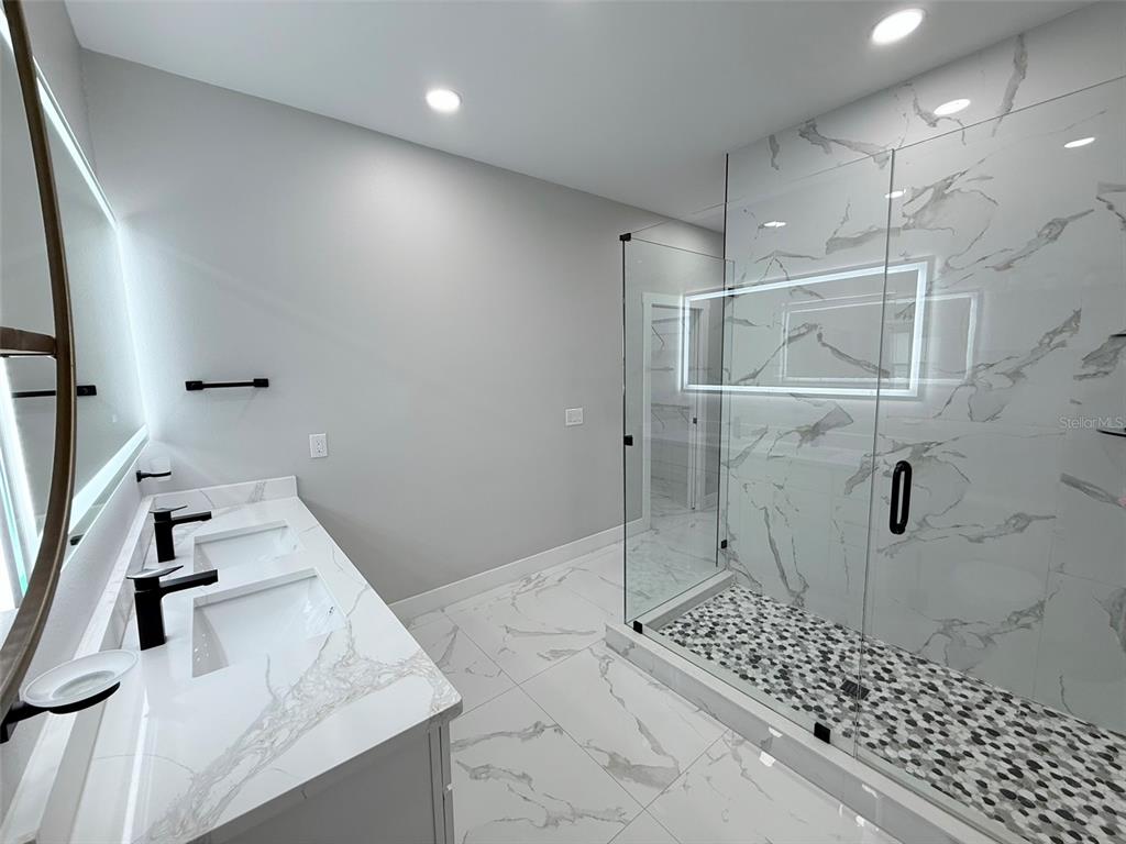 7403 Edgemere Road Tampa, FL 33625 - Photo 23 of 41 a bathroom with a shower