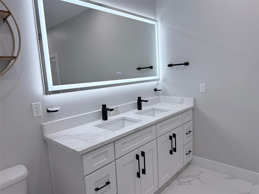 7403 Edgemere Road Tampa, FL 33625 - Photo 24 of 41 a bathroom with a sink and a mirror