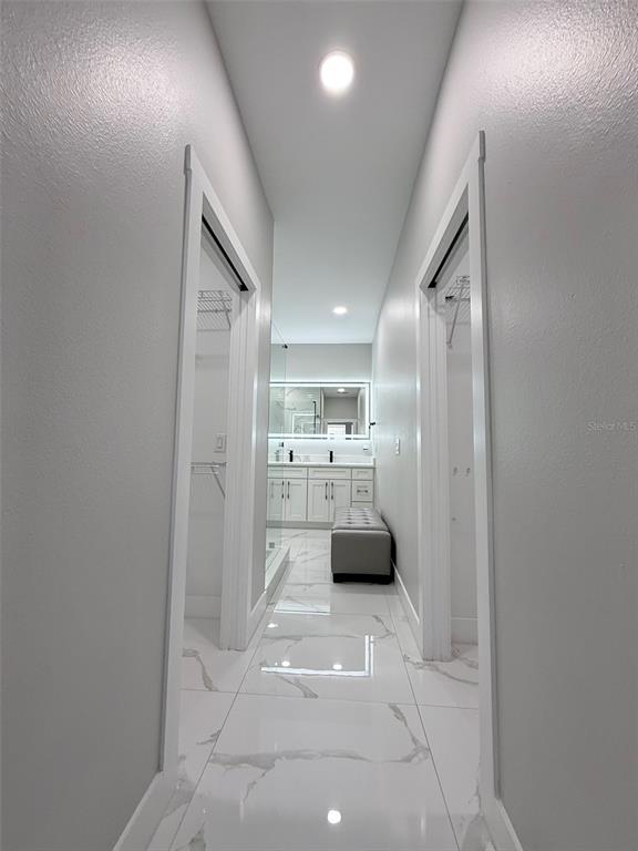 7403 Edgemere Road Tampa, FL 33625 - Photo 25 of 41 a view of a hallway with a sink and a refrigerator