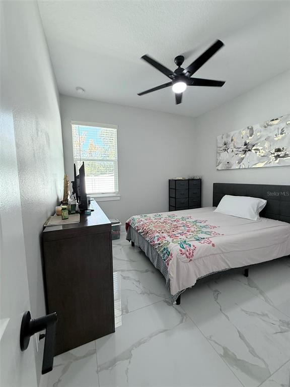 7403 Edgemere Road Tampa, FL 33625 - Photo 27 of 41 a bedroom with a bed and window