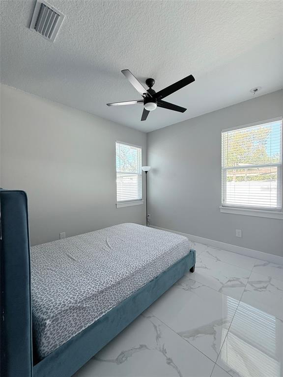 7403 Edgemere Road Tampa, FL 33625 - Photo 29 of 41 a bedroom with a large bed and a window