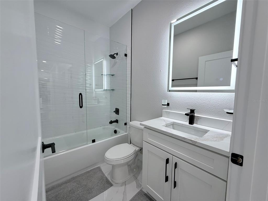 7403 Edgemere Road Tampa, FL 33625 - Photo 30 of 41 a bathroom with a sink a toilet and shower