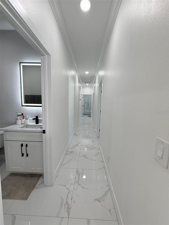 7403 Edgemere Road Tampa, FL 33625 - Photo 32 of 41 a bathroom with a sink vanity and mirror