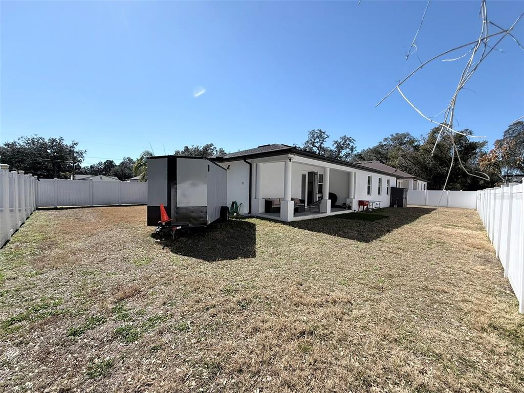 7403 Edgemere Road Tampa, FL 33625 - Photo 35 of 41 a view of a house with a yard