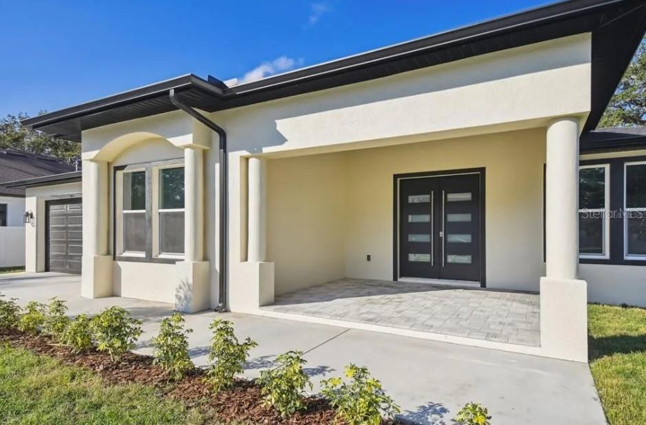 7403 Edgemere Road Tampa, FL 33625 - Photo 40 of 41 a front view of a house with a yard