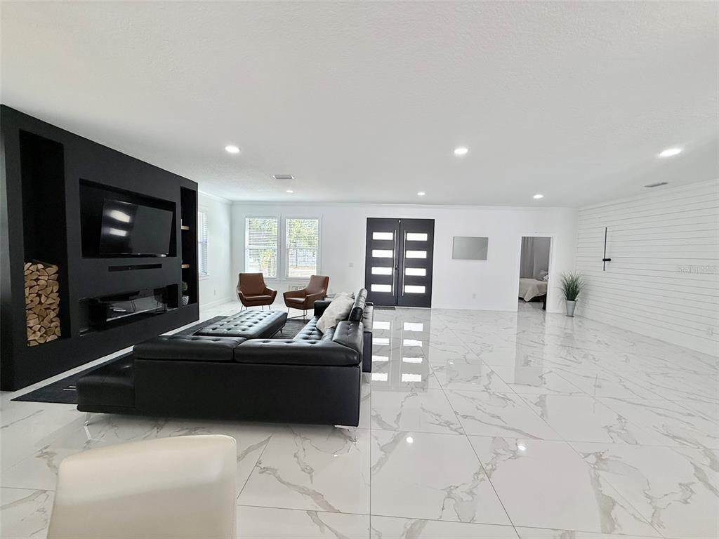 7403 Edgemere Road Tampa, FL 33625 - Photo 5 of 41 a living room with furniture and a flat screen tv