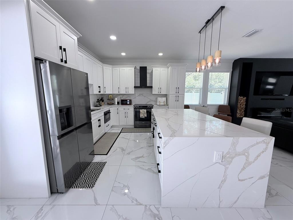 7403 Edgemere Road Tampa, FL 33625 - Photo 7 of 41 a large white kitchen with lots of appliances and cabinets