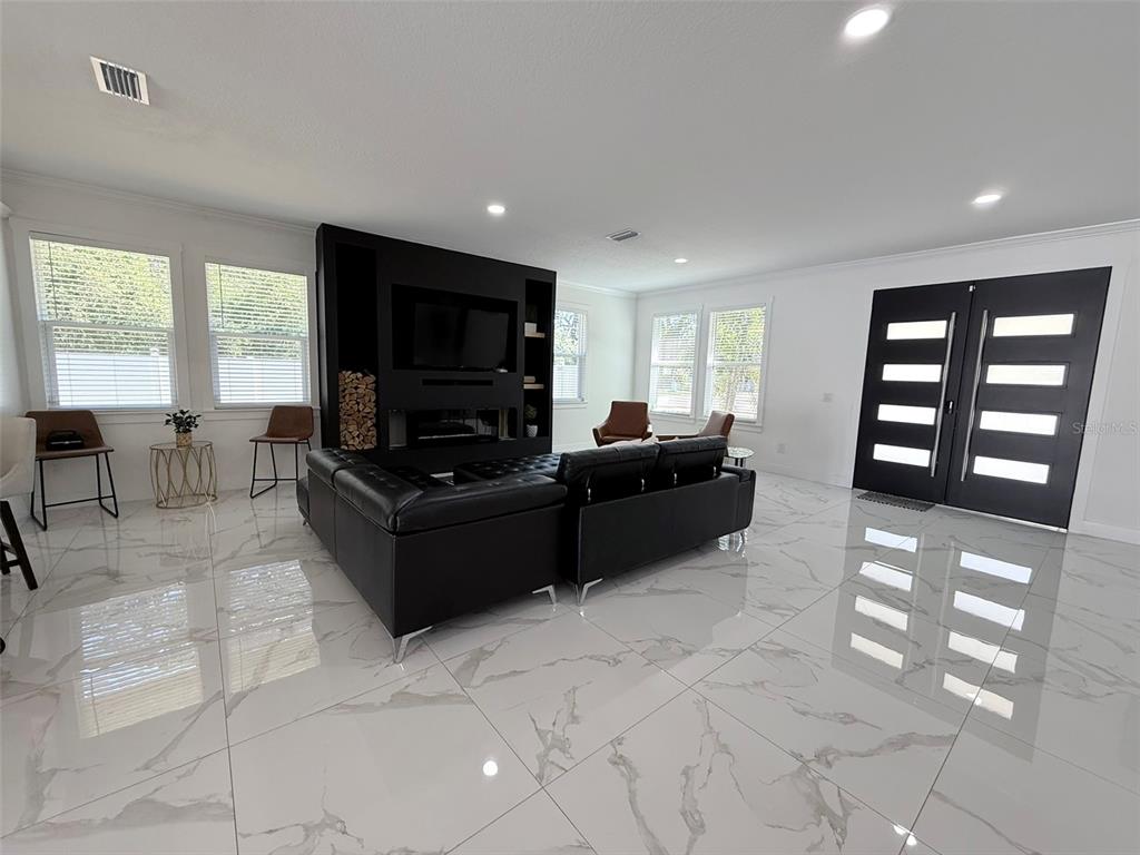 7403 Edgemere Road Tampa, FL 33625 - Photo 9 of 41 a living room with furniture and a flat screen tv