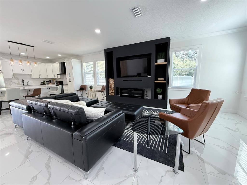 7403 Edgemere Road Tampa, FL 33625 - Photo 10 of 41 a living room with furniture and a flat screen tv