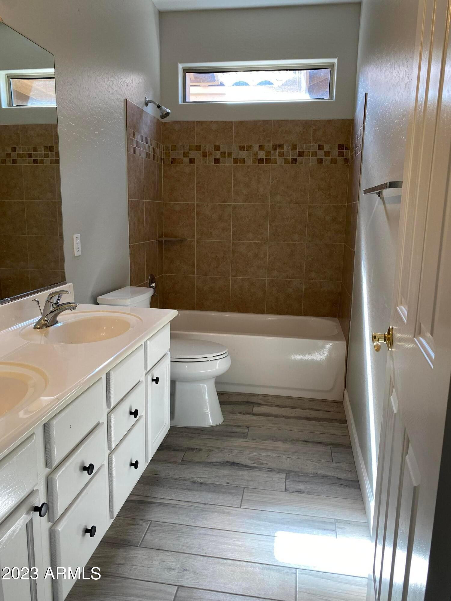 232 West Hawk Way Chandler, AZ 85286 - Photo 10 of 16 a bathroom with a double vanity sink toilet mirror and shower