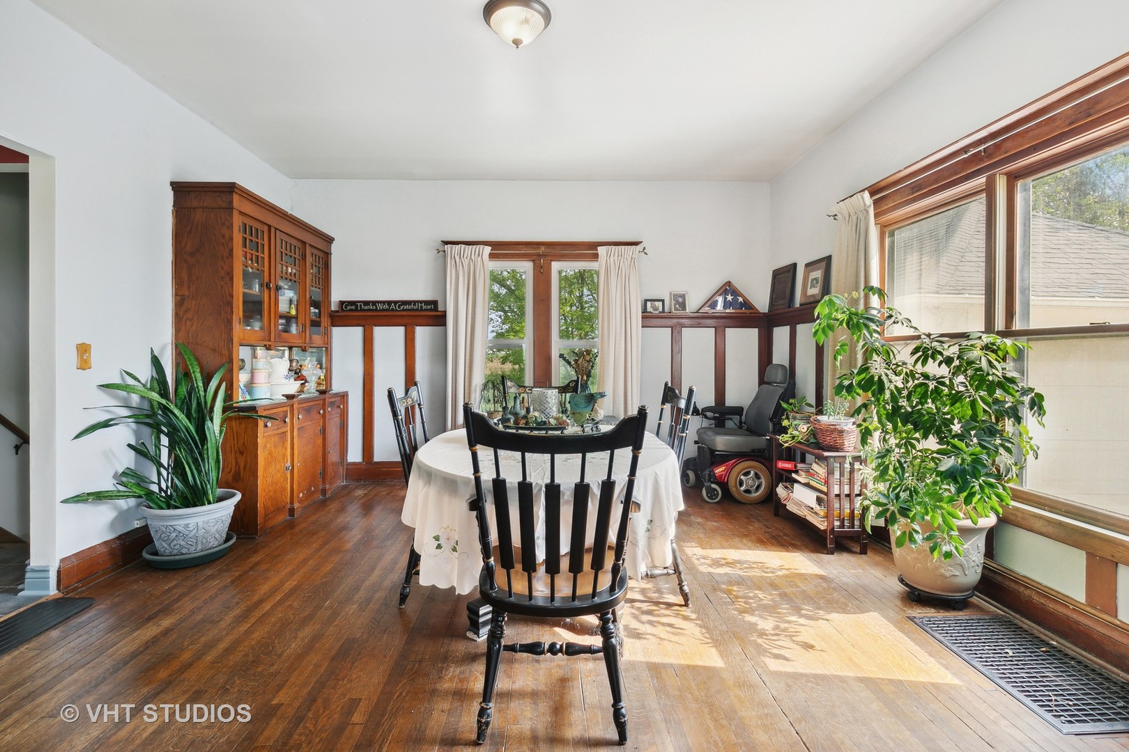 45W740 Read Road Maple Park, IL 60151 - Photo 11 of 26 a living room with furniture dining table a potted plant and a window