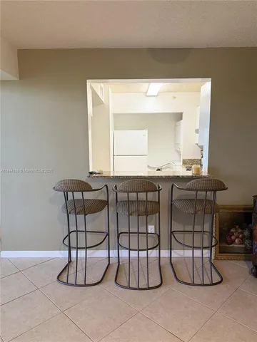 a room with a table chairs and entryway